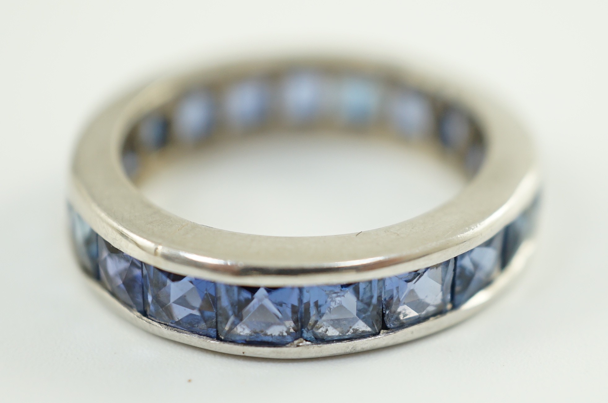 A platinum? and square cut sapphire set full eternity ring